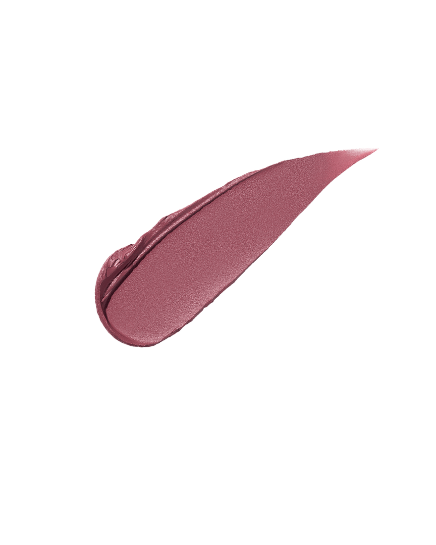 A smear of Fenty Icon Velvet lipstick in mauve color on a light background.